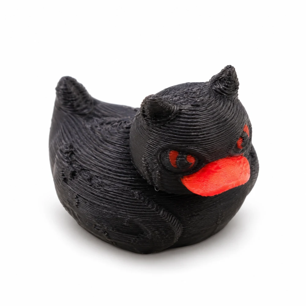 One black 3D printed devil duck with a red-orange bill and red details